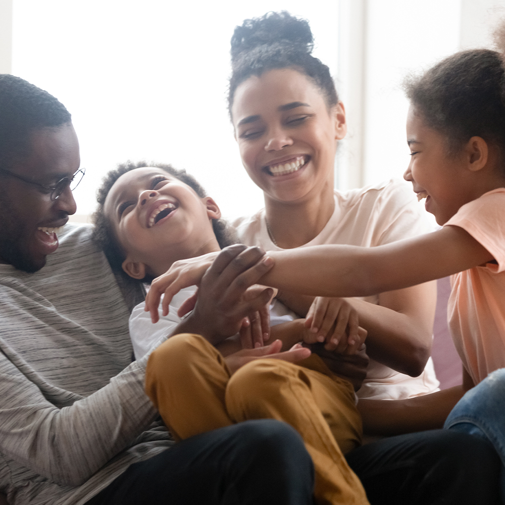 Happy family playing on a couch