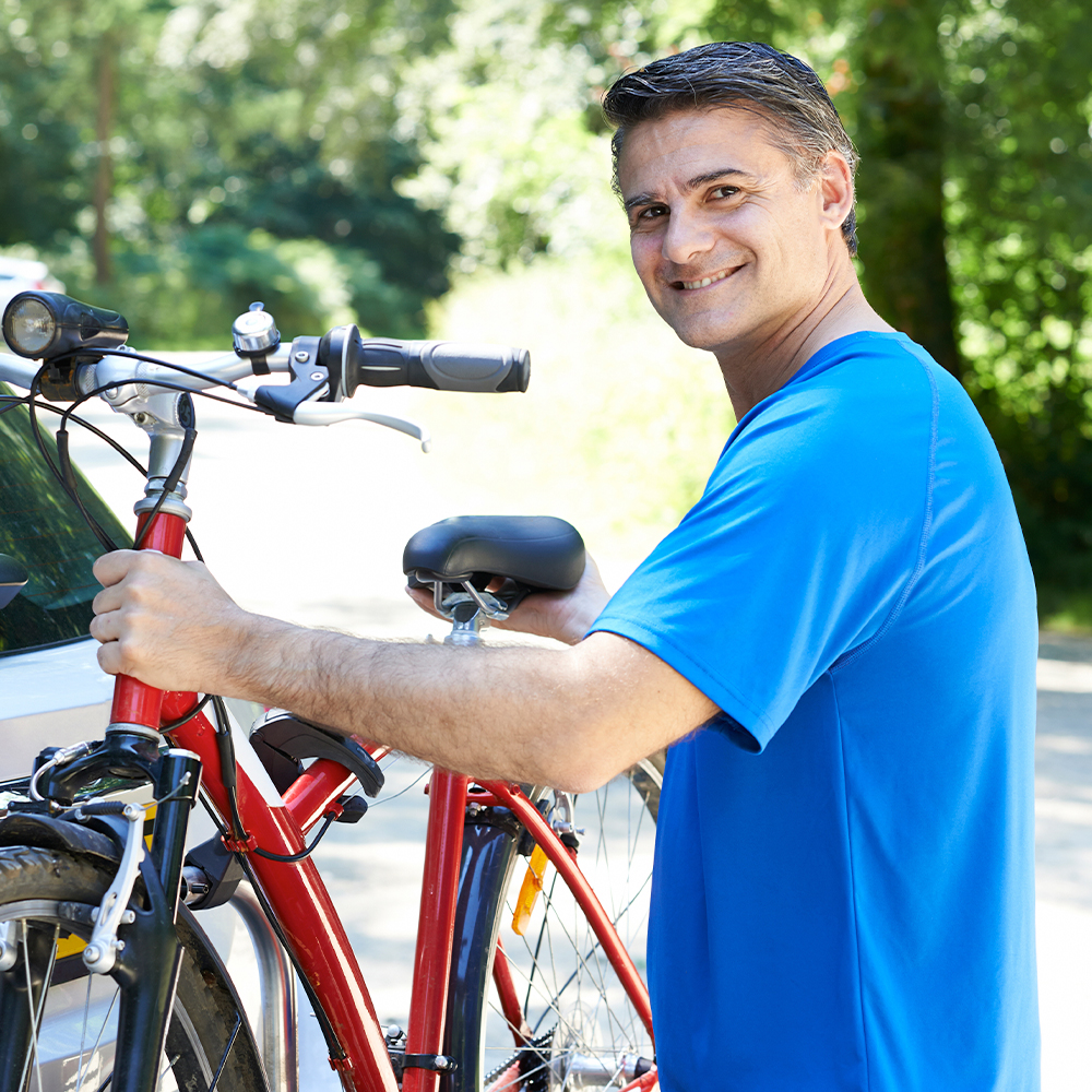 A confident middle-aged man sharing a bright, healthy smile.
